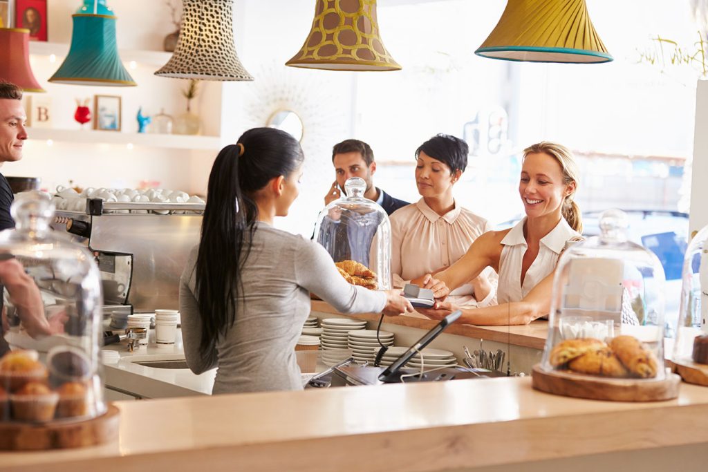 Business owner serving customers and wondering if her marketing is working