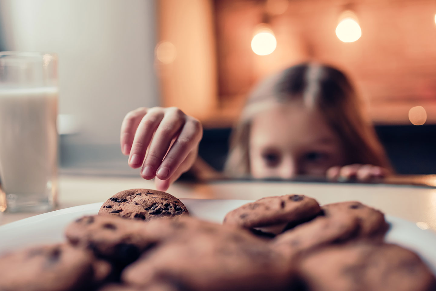 Girl stealing cookies. Not website cookies. Just normal cookies. Chocolate chip.