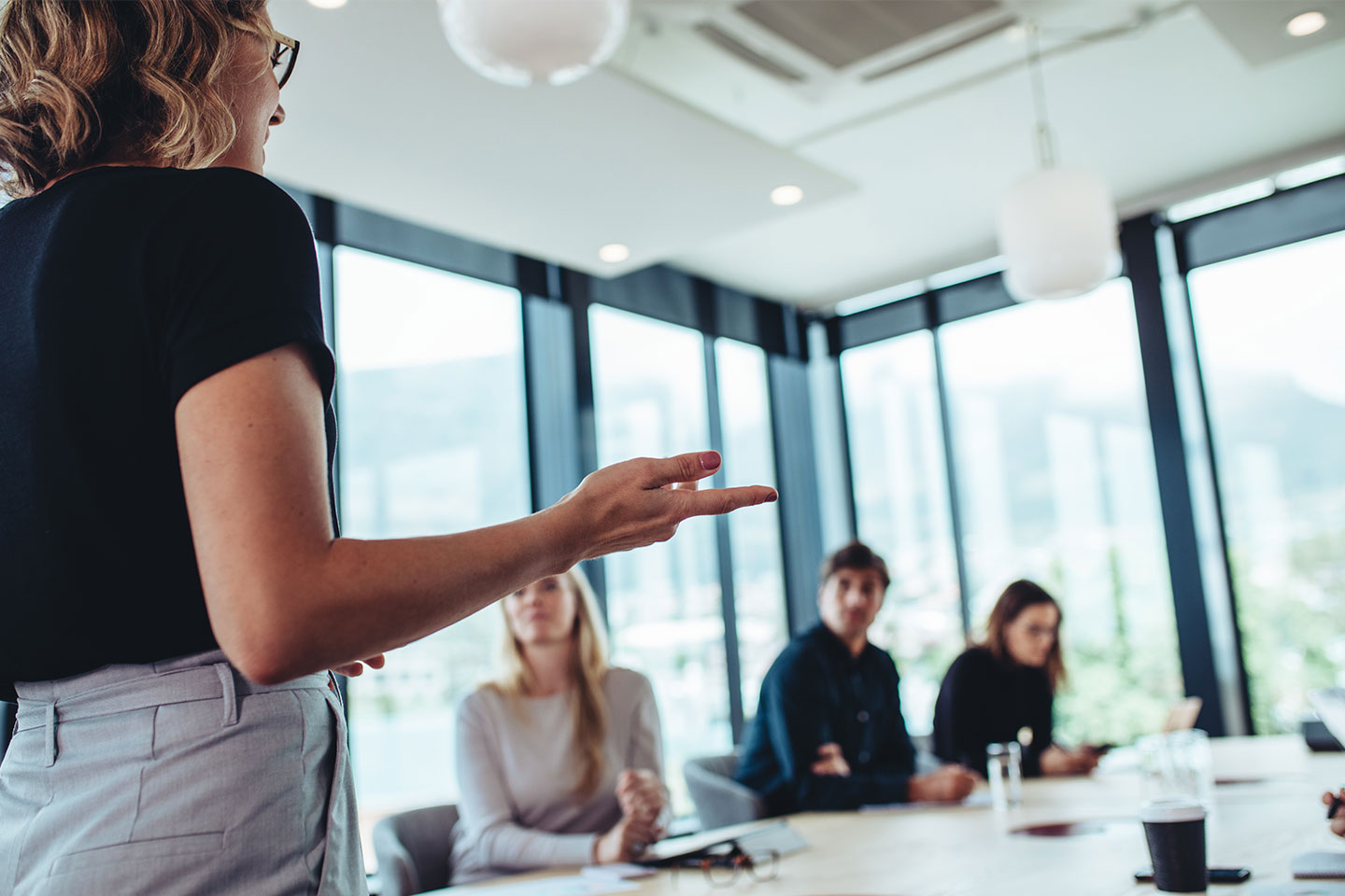 Woman talking with her team about website strategy and improving website performance